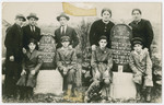 The  Struczanski family gathers by the tombstones of Avraham Yaakov and Liba Devorah  Struczanski.