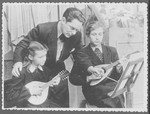 Elja Heifecs gives mandolin lessons to two students.