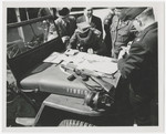 A Polish officer signs paperwork for  the transfer of German prisoners back to Poland for trial.