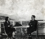 Matthieu and Alice Mueller sit by a table overlooking the lake in Geneva.