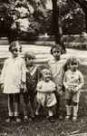 The five Birnbaum siblings pose on a grassy lawn in Berlin.