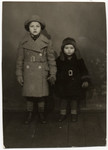 Portrait of sisters Nelly and Lilly Rattner, wearing coats made for them by their uncle Richard, a tailor.