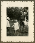 Marguerite-Rose Birnbaum holds hands with Marcq Dincq, the son of her rescuers, Pierre and Marie-Josephe Dincq while a goat stands to the side.