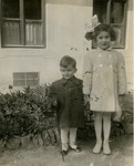 Siblings Villiam and Helene Doris Krausz stand outside their family's home in Nitra.