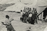 An Italian soldier takes a photo of a group of prisoners outside a tent in the Preza labor camp.