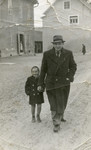 Miriam Steiner and her father walk down the street in front of the pharmacy where he works.