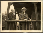 Bela and Leo Stern (the great-grandparents of the donor) pose on the balcony of a wooden building.