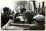 Julien Bryan's driver stops Bryan from waving to a crowd of Polish spectators in besieged Warsaw.