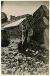 Mendel Grossman poses in front of the ruins of the  Alte Shul (Old Synagogue) on Wolborska Street, which was blown up by the German authorities.