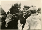 Jews who have been selected for deportation, bid farewell to their families through the wire fence of the central prison, during the "Gehsperre" action in the Lodz ghetto.