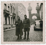 Leopold Guttman stands next to a friend on a street in Antwerp.
