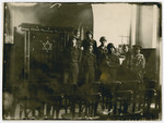 Leopold Guttman, Henry Kahn and other Jewish soldiers pose by the Toah ark in the newly restored synagogue in Wunsdorf after making townspeople repair it and the Jewish cemetery, both of which had been desecrated during the Holocaust.