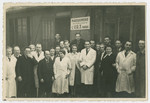 Group portrait of French survivors standing in front of an ORT leather-making workshop.