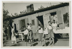 A group of boys from Haus Berta, a summer camp started in 1934 and sponsored by the Reich Federation of Jewish Front Soldiers, enjoys a snack outside a barrack.
