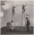 Members of a Jewish labor battalion paint the interior of a building in Hajduhadhaz.
