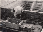 A members of a Jewish labor battalion lays bricks in Hajduhadhaz.