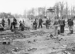 Recently liberated prisoners prepare food in the open at Buchenwald.