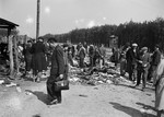 Former concentration camp inmates search through clothing and other effects after the liberation of Buchenwald.
