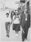 The Willenberg family walks down a street in prewar Czestochowa.