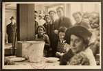 Men and women gather in the kitchen of the Jewish Refugee Aid Committee of Antwerp.