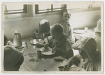 German Jewish refugee children eat a meal in a children's home in France.
