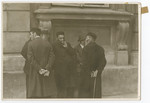 A group of Jewish men gather outside the stock exchange in Warsaw.