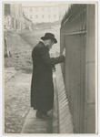 A religious Jewish man leans against a wall [possibly in prayer.]

Photograph is used on page 146 of Robert Gessner's "Some of My Best Friends are Jews."