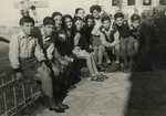 Nadia Cohen (with short hair) poses with the children that she is taking care of in settlement.