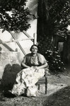 Terese Cohen sits in a garden wearing traditional dress.