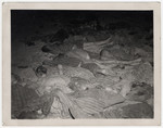 View of corpses on a straw laden floor in the Nordhausen concentration camp.