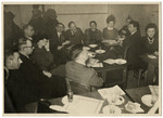 Meeting of a group of Belgian Jews.  [It is unclear if this is wartime or postwar.]

Among those pictured are Yitzchak Kubovitsky (third from left), Israel Tabakman (fifth from left facing camera with glasses), Nahum Pomerantz (third from right), Izak Szattan (second from right) and Fela Perelman at the far right.