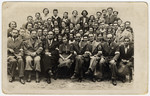 Group portrait of employees of the postal service in the Lodz ghetto.