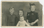 Aaron Jedwab, a Jewish infant in hiding as Jan Willem Herfstein, poses with his foster siblings Dick, Janni and Ina Wikkerink.