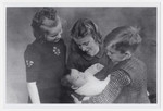 Aaron Jedwab, a Jewish infant in hiding as Jan Willem Herfstein, is cradled by his foster siblings Dick, Janni and Ina Wikkerink.