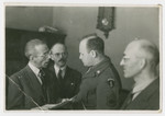 Jewish American serviceman and JDC aid worker David Eizenberg meets with three men in postwar Berlin.