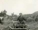 Victor Tulman cooks in a makeshift outdoor kitchen during the Spanish Civil War.
