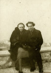 Victor Tulman and Hella Bacmeister, both internees in Gurs, rest on a ledge while on an outing in Marseilles.