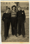 Irena Wojcik poses with two friends in factory uniforms in either the  Aschaffenberg or Wildflecken displaced persons camp.