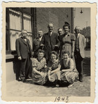 A Jewish businessman poses with the workers in his textile factory "M.