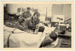German army physician Bernhard Kullak peforms a medical examination in either a field hospital or training facility.