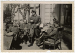 A group or German soldiers relaxes outside a home in Paris.