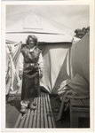 A woman stands in front of a tent [probably Ulla Dahlgran].