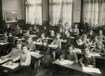 Girls in the fourth grade class in Dordrecht sit at their desks.