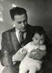 Studio portrait of Emil Goldberg holding his baby son Edwin (Edik)