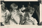 Two young children from the Lindenfels school enjoy slices of orange.