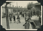 Children and adults gather on a street in the Ziegenhain displaced persons camp.