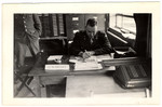 Lieutenant Myron Moses writes at his desk in the offices of the Signal Corps in Suippes, France.