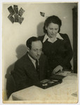 A Jewish couple examines a photo album in the Feldafing displaced persons camp.