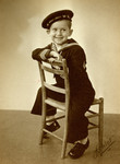 Postwar studio portrait of Zeev Jonas wearing a sailor suit.