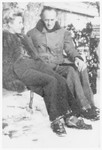 Jacqueline Lamba Breton and Victor Brauner sit outside on a bench at the Villa Air-Bel on a snowy day.